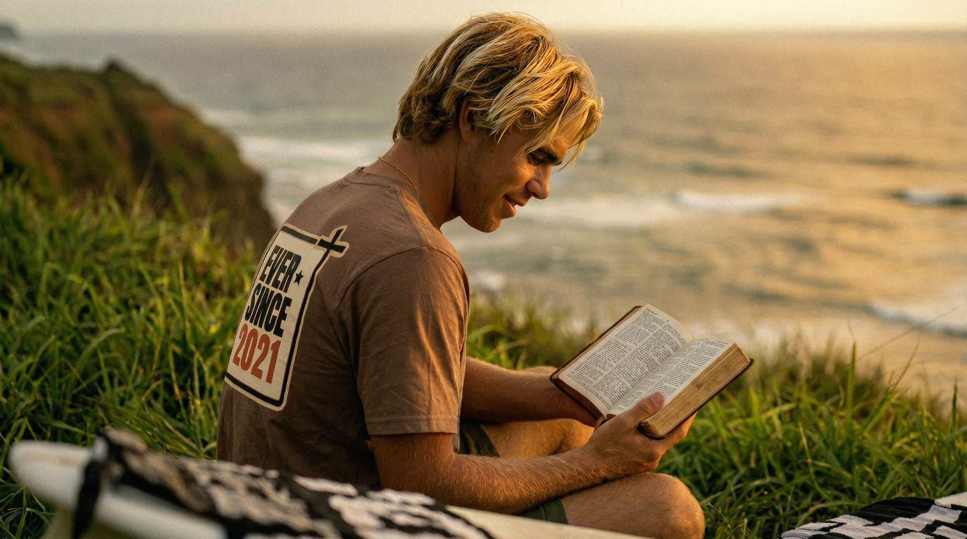 Finn reading the Bible, wearing an EverSince tee personalized with his year of salvation